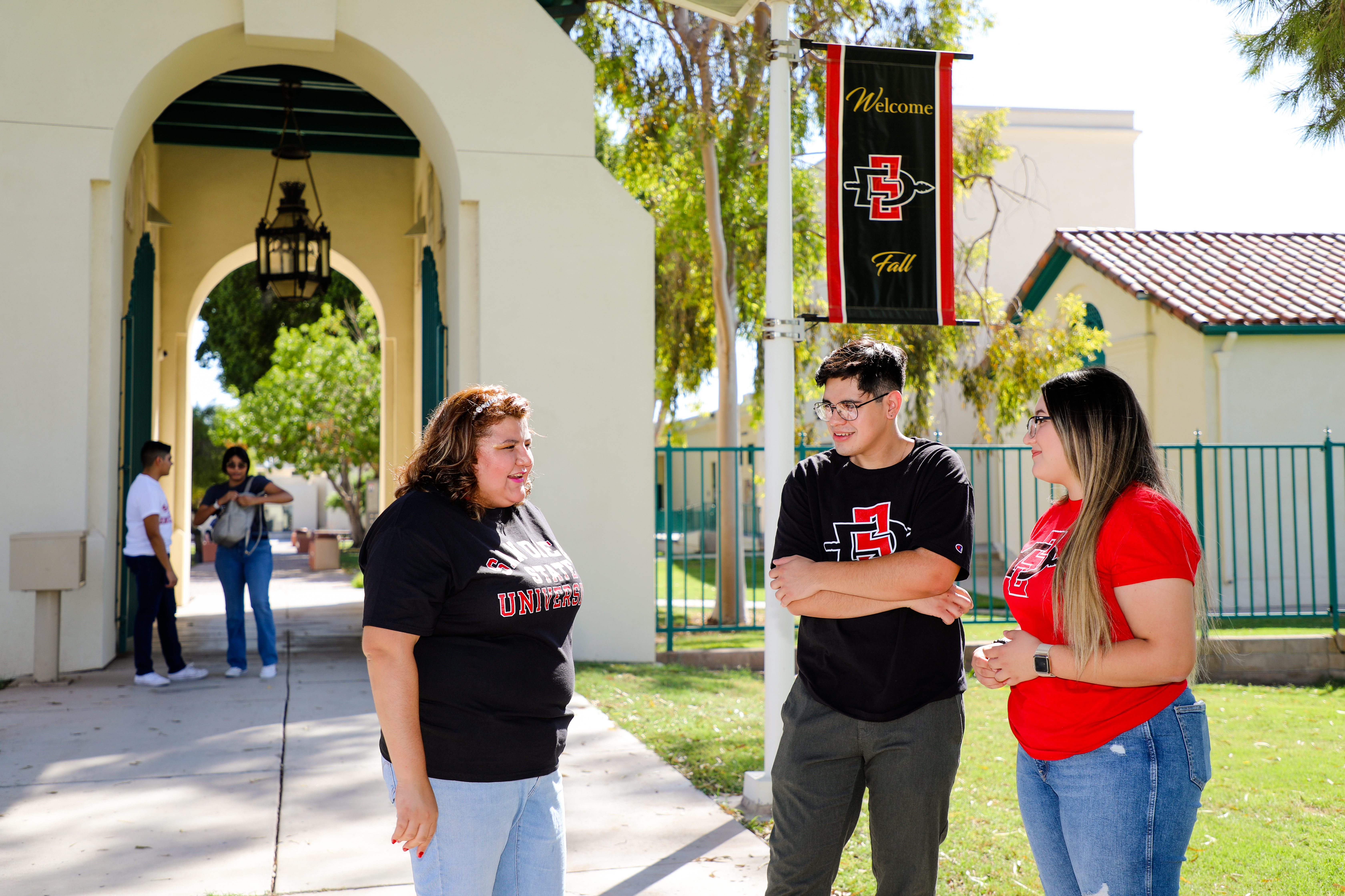 A group of students smiling and facing away from the camera