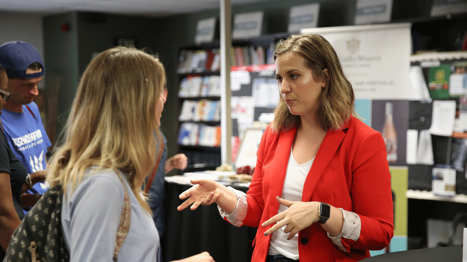 A recruiter speaking to a student at a career fair.