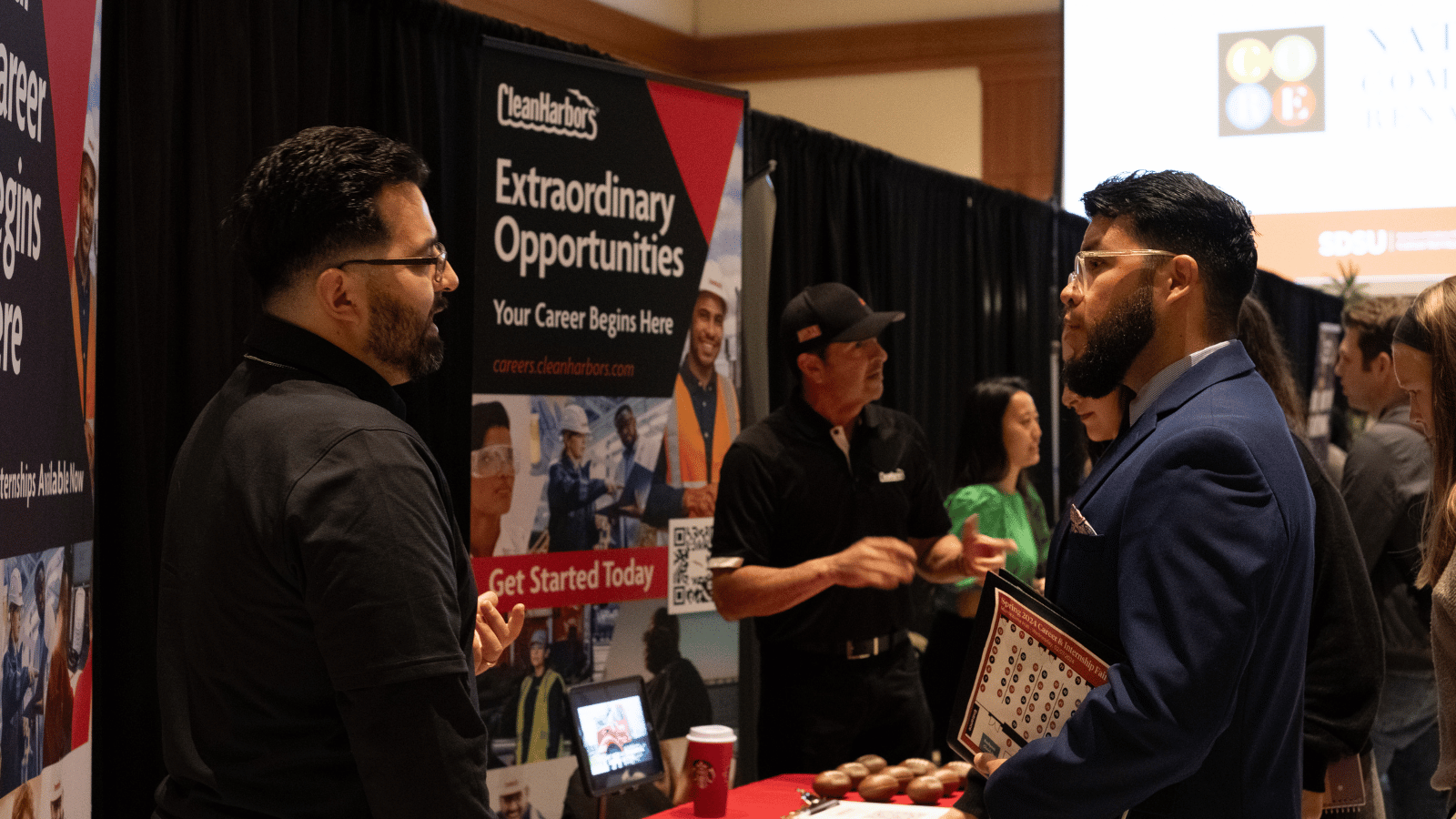 A recruiter speaking to a student at a career fair.