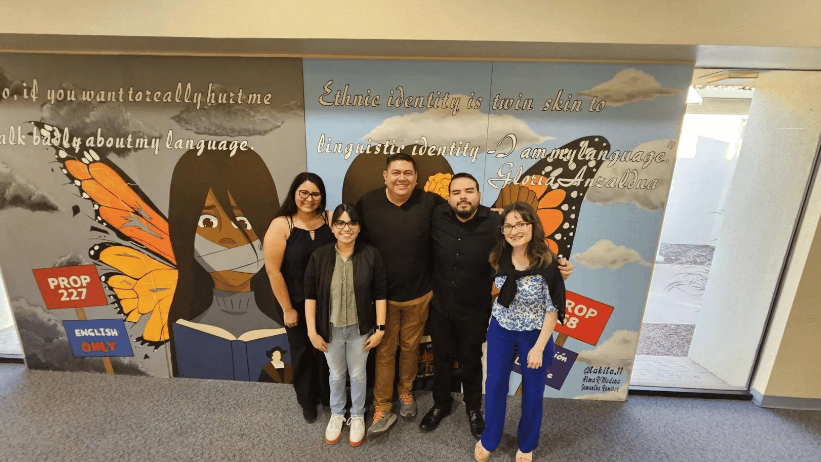 SDSU Imperial Valley staff members standing in front of a mural.